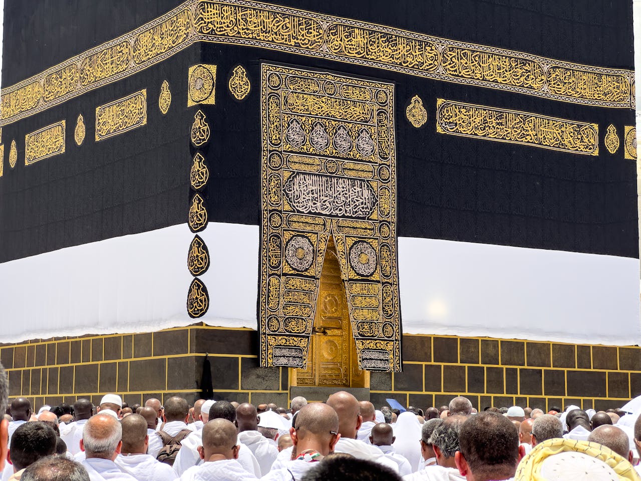 services-01 A gathering of pilgrims around the sacred Kaaba in Mecca, a significant Islamic site.